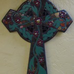 Celtic cross in green and red ceramic mosaic